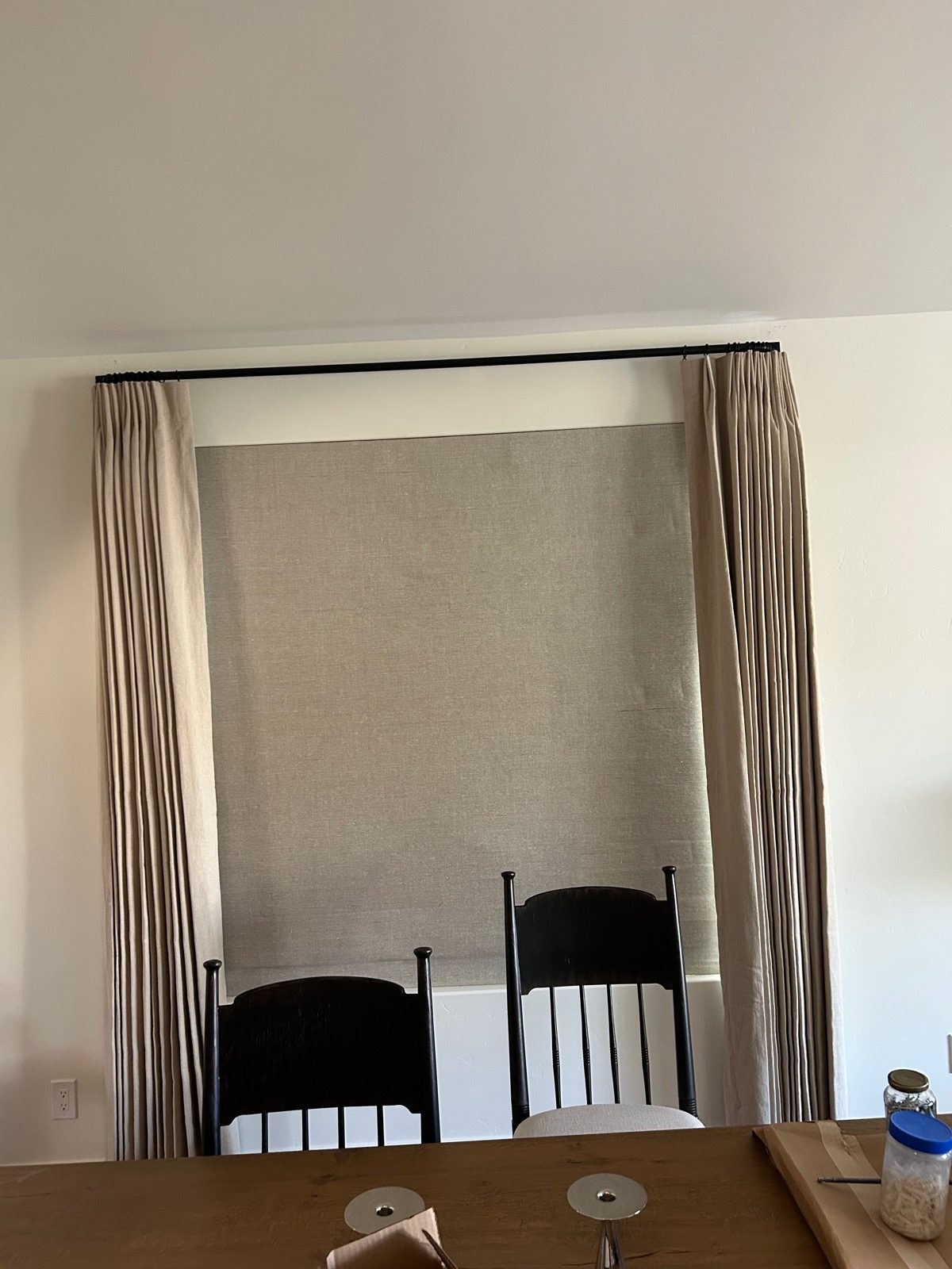 Linen roman shade with custom drapery panels in a Tucson dining space