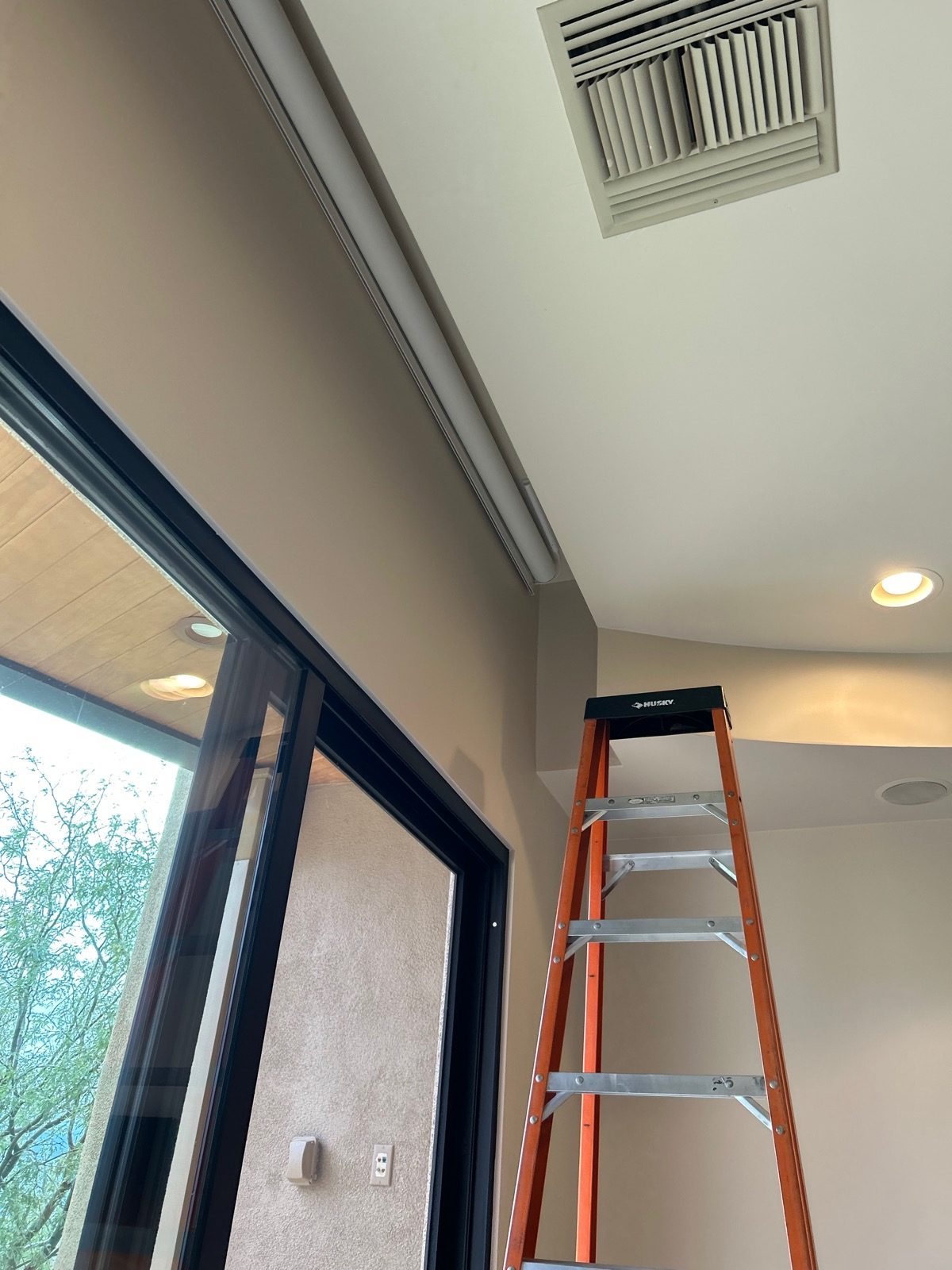Motorized shade ceiling pocket installation in a Tucson home