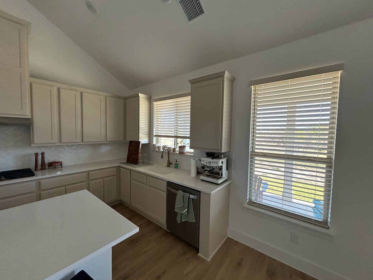 Faux wood blinds in a kitchen by Love Is Blinds Arizona