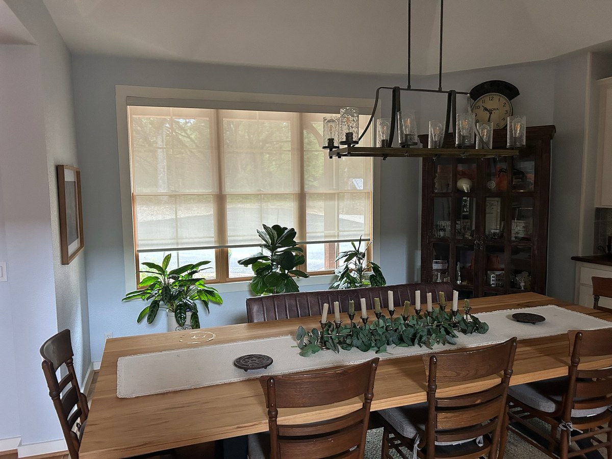 Woven wood shades in a dining room by Love Is Blinds Arizona