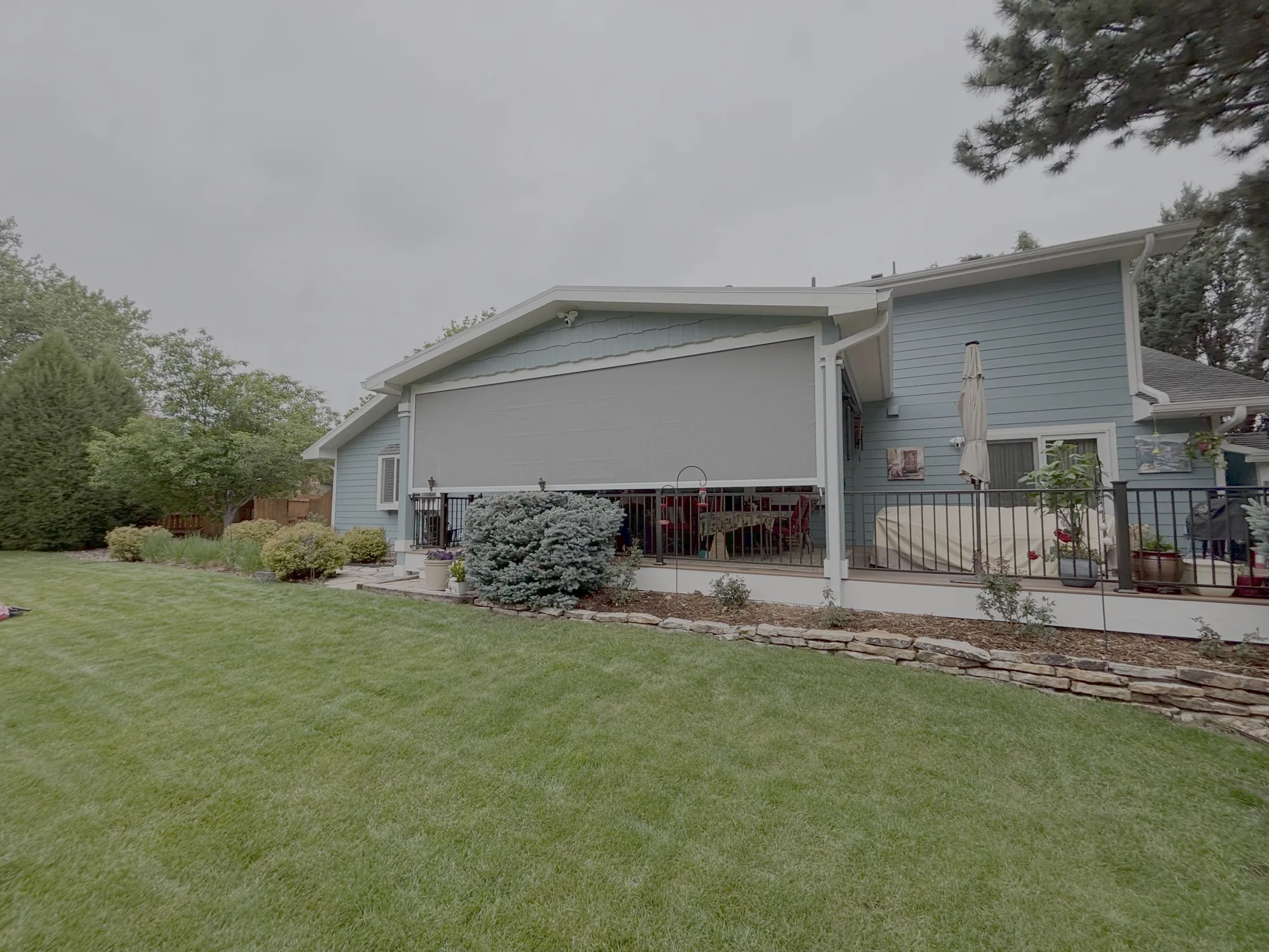 Exterior shade screens on a home installed by Love Is Blinds