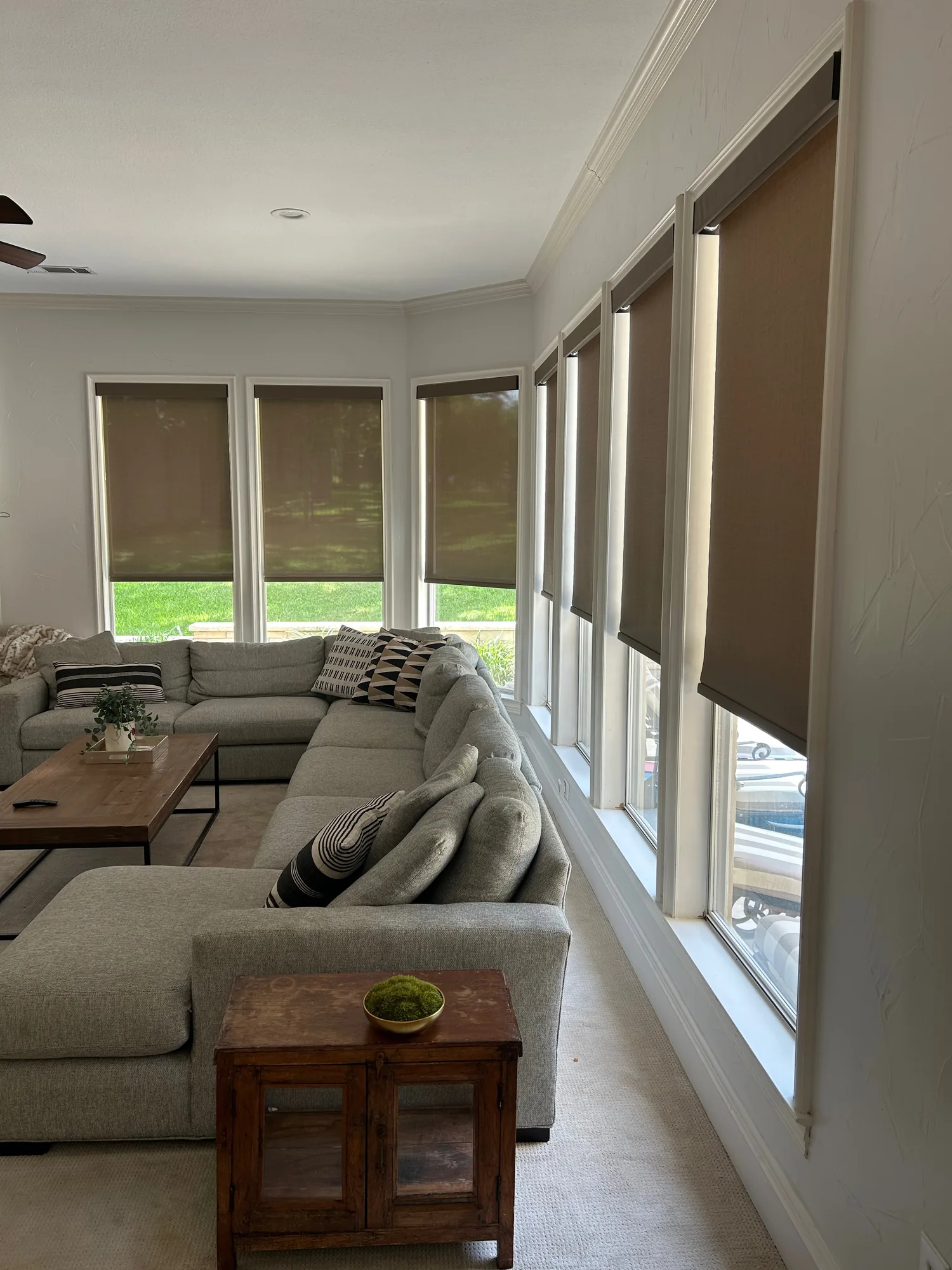 Sunroom with custom roller shades installed by Love Is Blinds