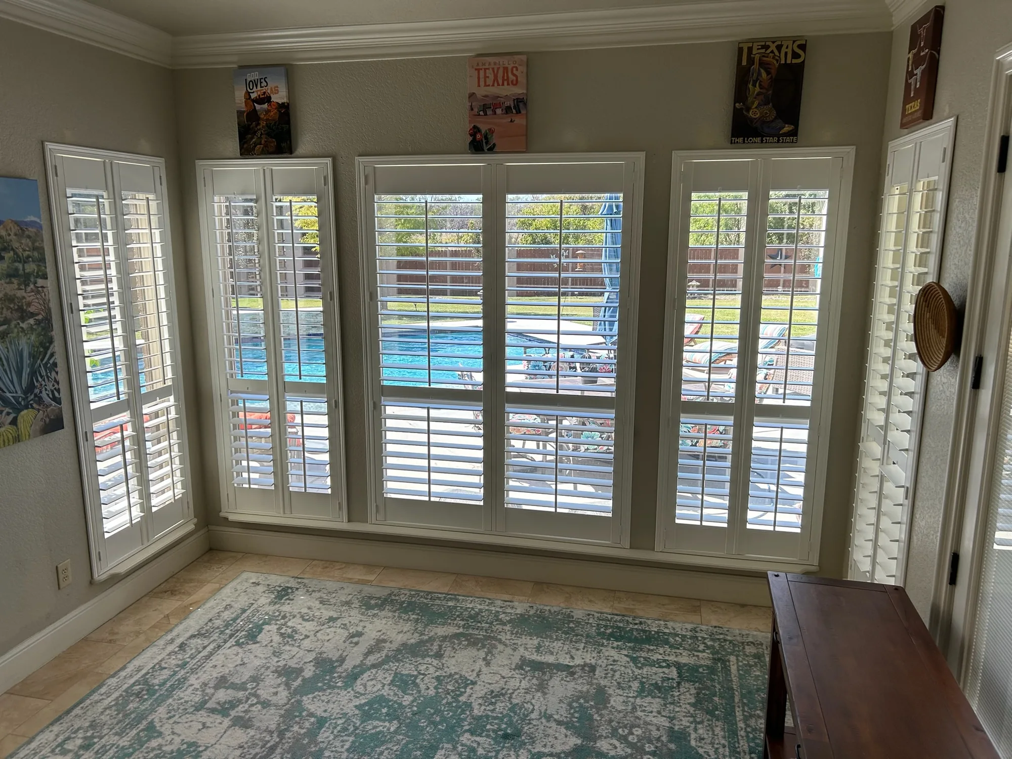 Sunroom wall of plantation shutters installed by Love Is Blinds
