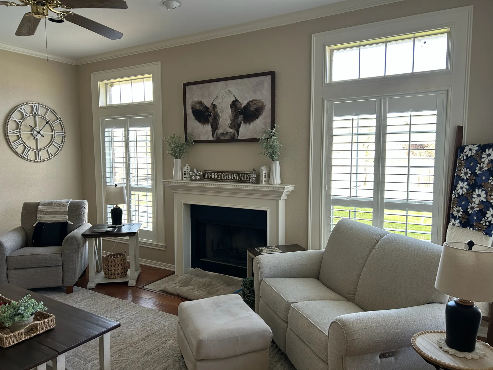 Living room with tall shuttered windows installed by Love Is Blinds
