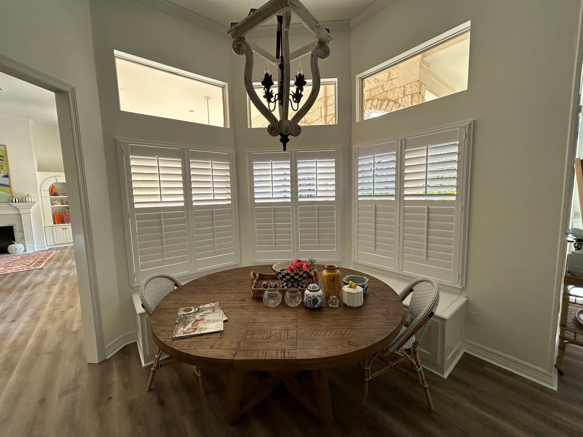 Dining nook with plantation shutters installed by Love Is Blinds