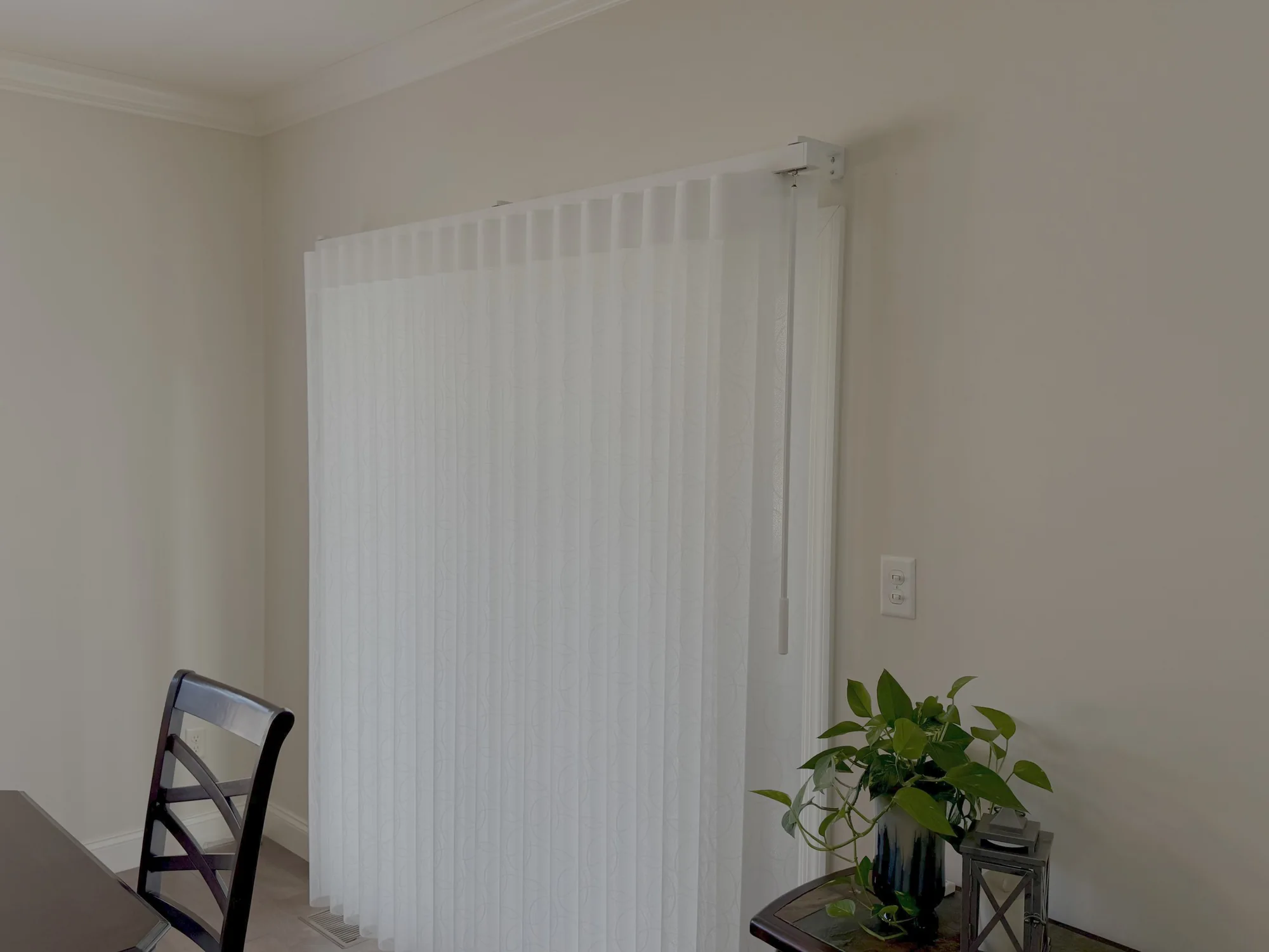Sliding panel window treatment on a glass door installed by Love Is Blinds