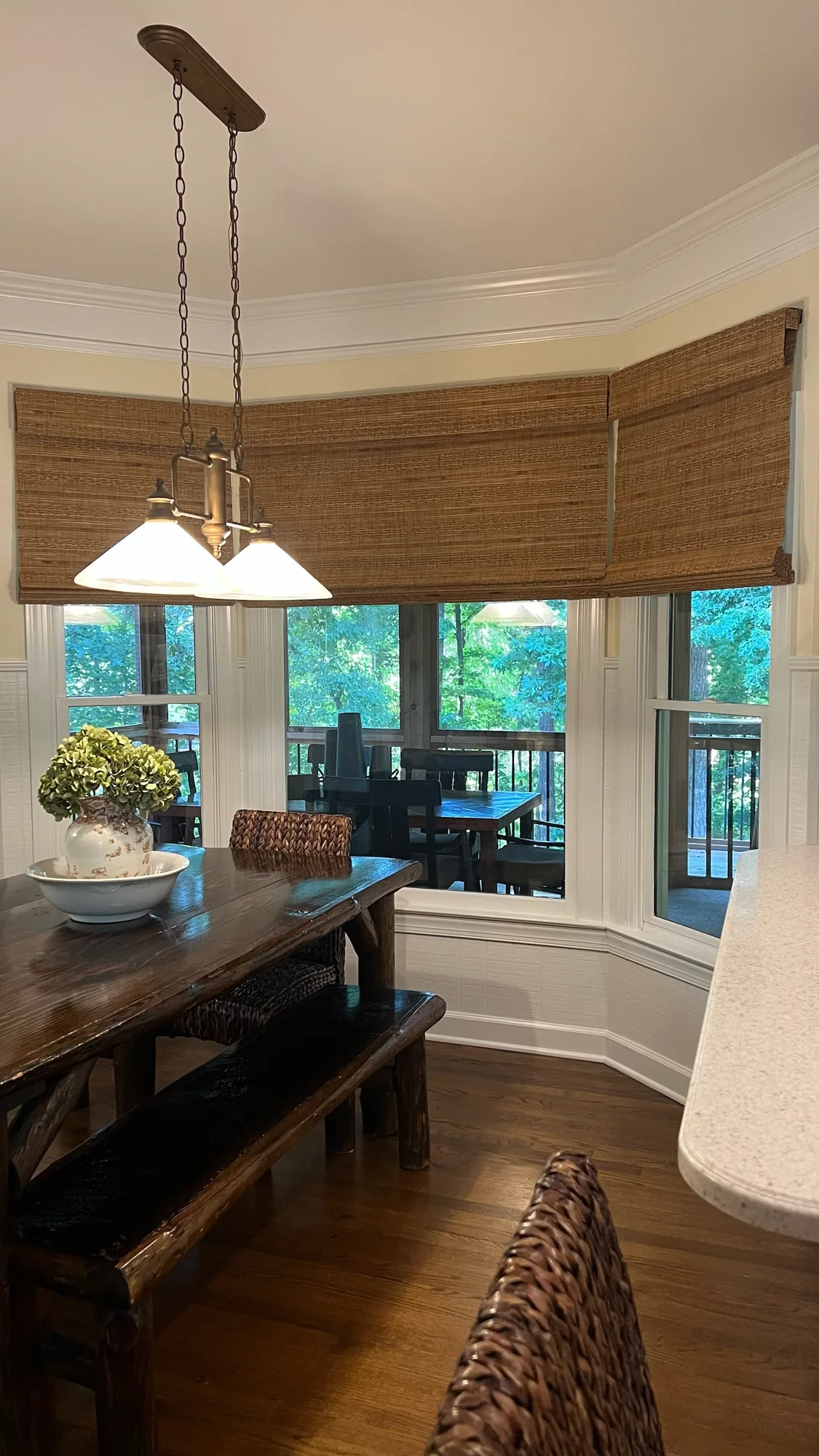 Bay window with woven wood shades installed by Love Is Blinds